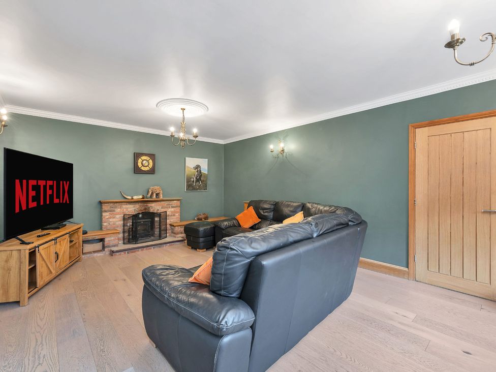 A living room with a TV and fireplace at Oldfields