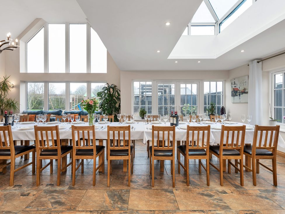 A dining room with a long table and chairs at Oldfields
