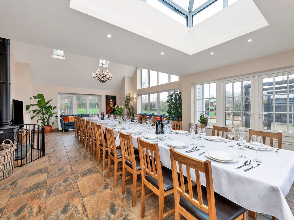 A dining room with a long table and chairs at Oldfields