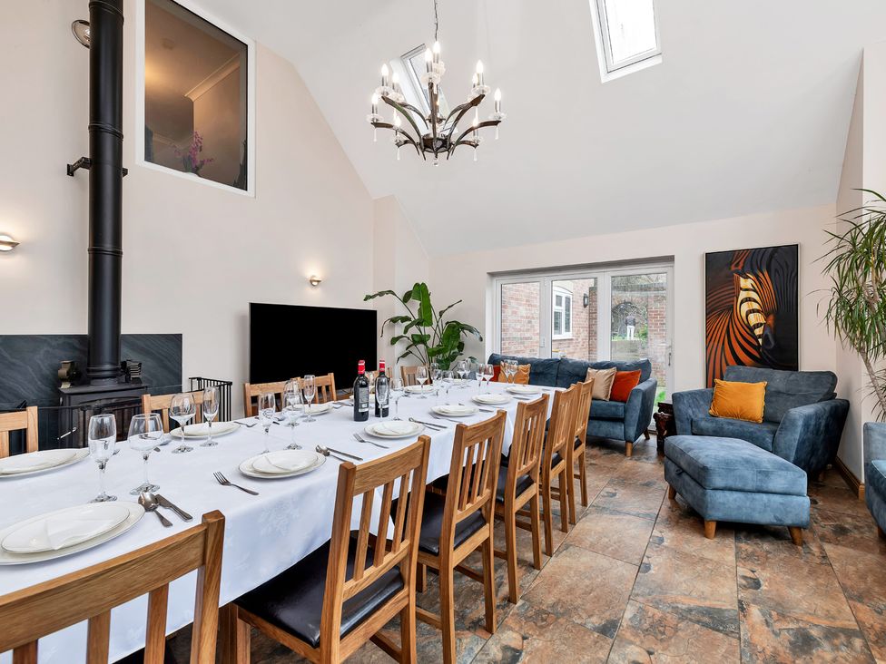 A dining room with a long table and chairs at Oldfields