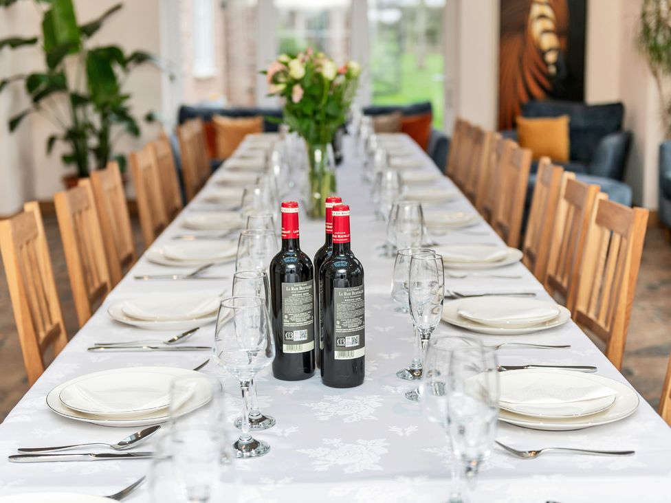 A dining room with a long table set for a meal at Oldfields