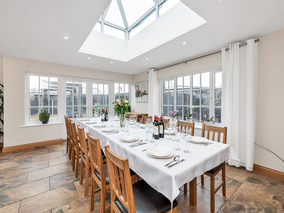A dining room with a long table set for a meal at Oldfields