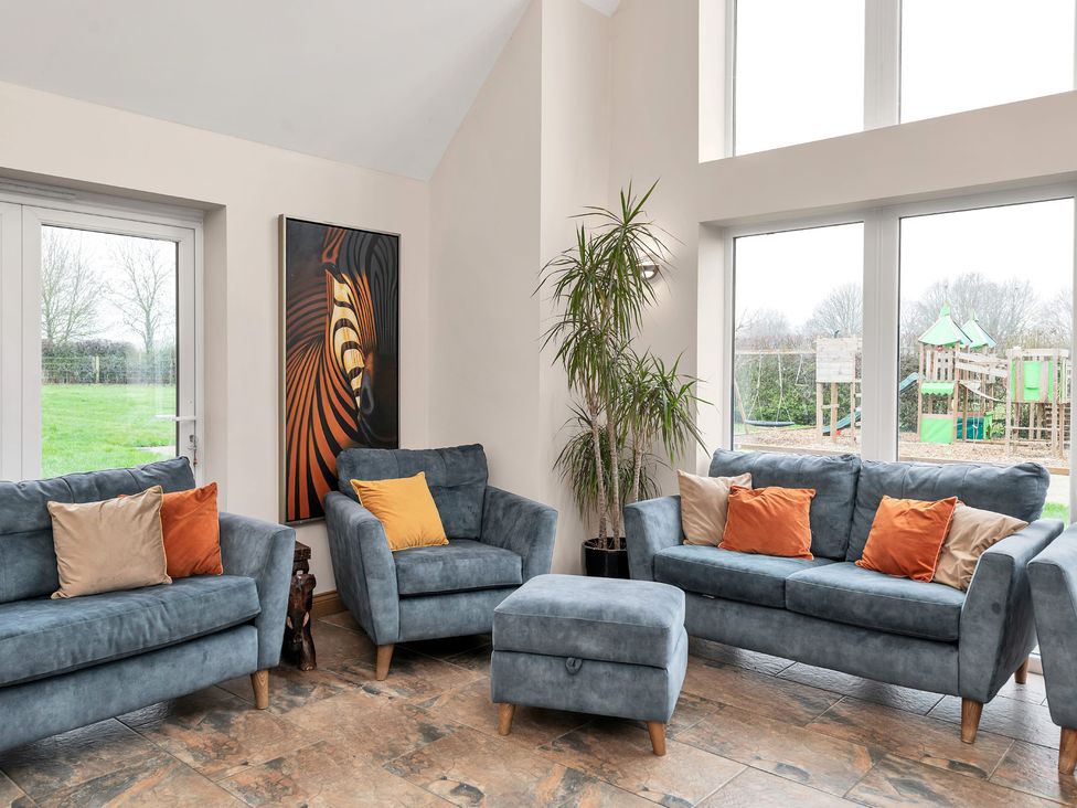 A living room with sofas and a plant at Oldfields