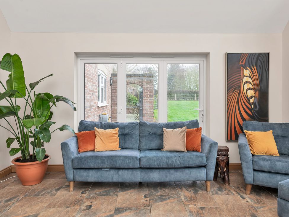 A snug with a couch and a plant at Oldfields