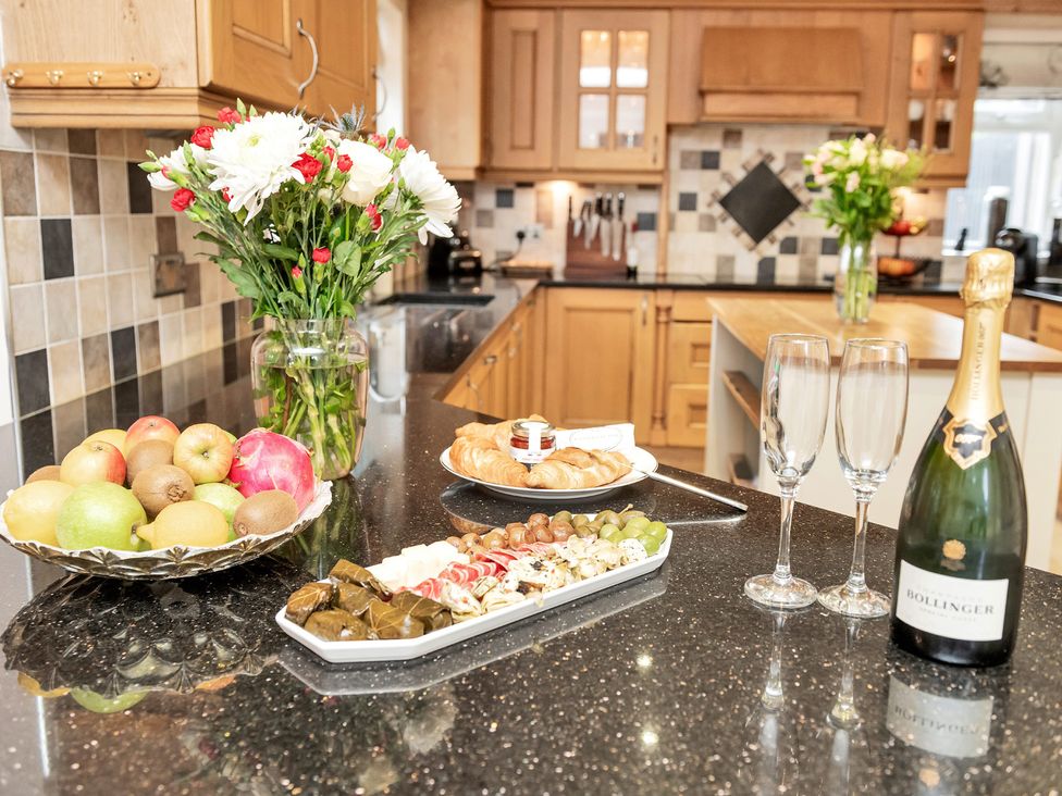 A kitchen with food and drinks on the counter at Oldfields