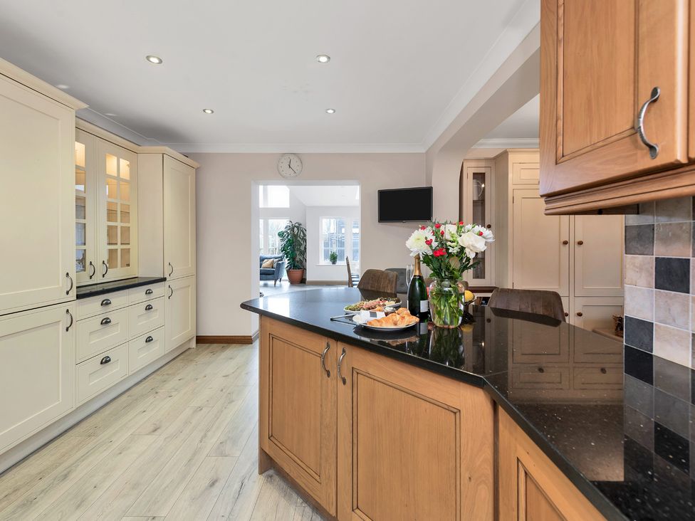 A kitchen with wooden cabinets and an island at Oldfields