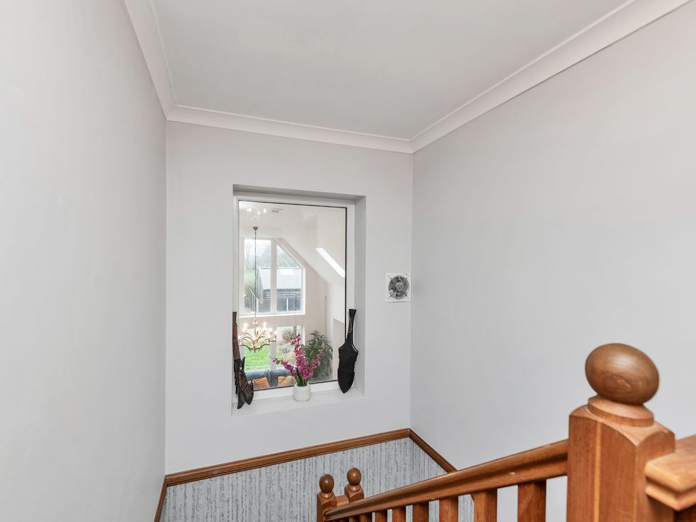A staircase with a window and plants at Oldfields