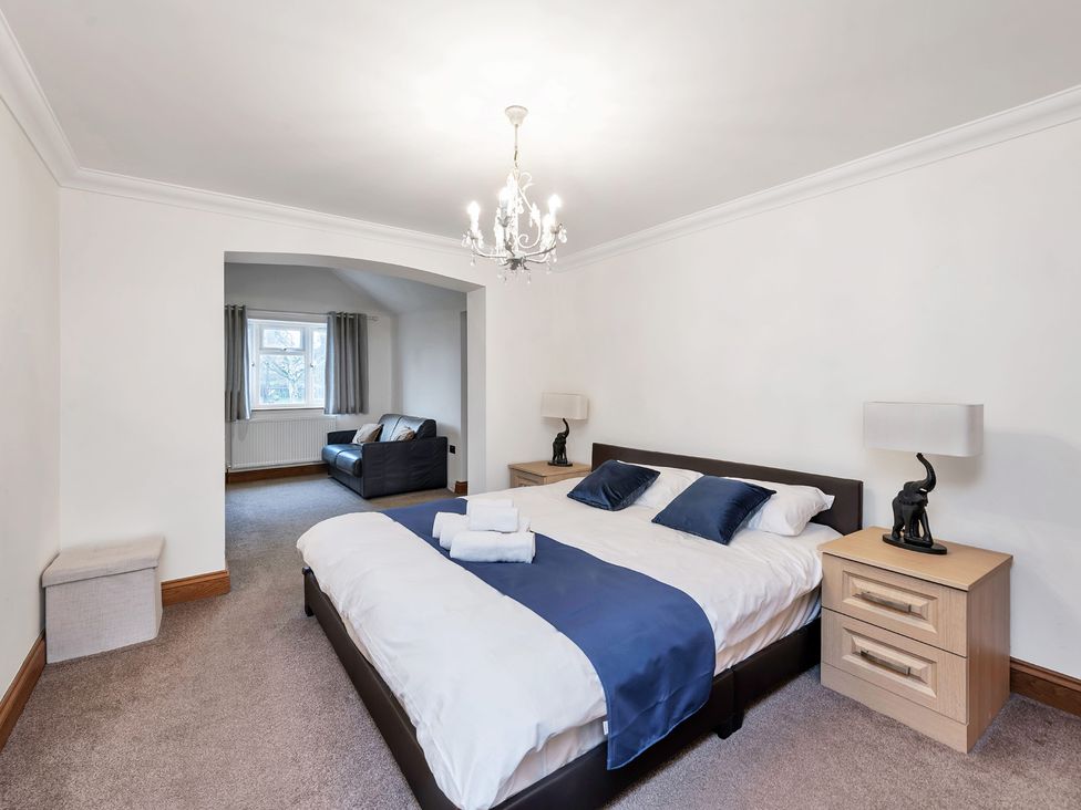A bedroom with a bed and sofa at Oldfields