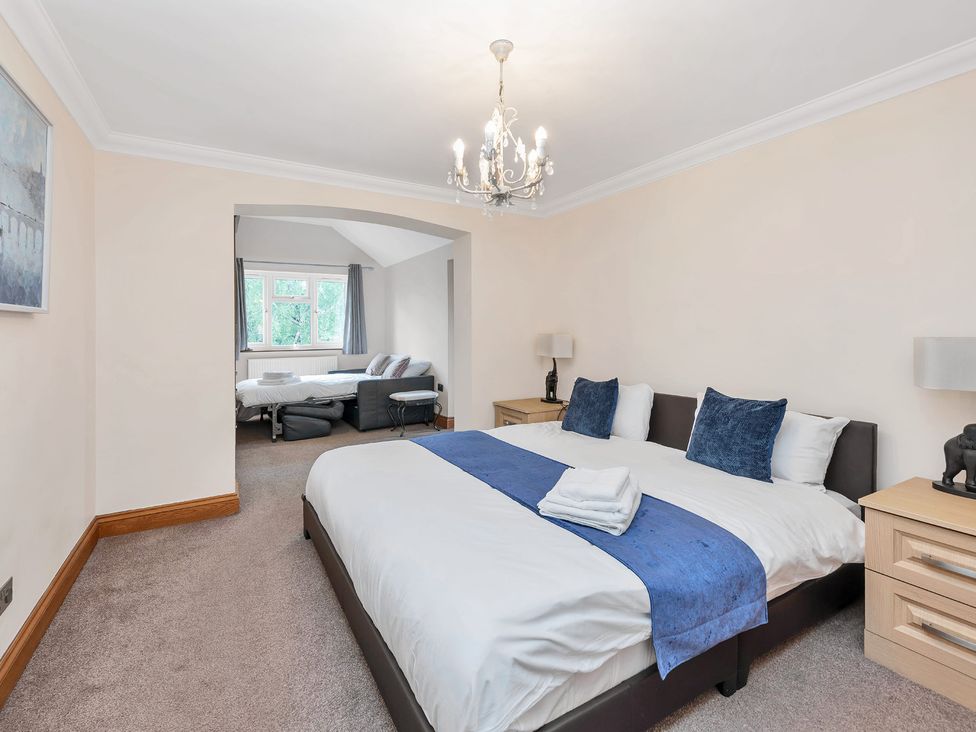 A bedroom with two beds and a sofa at Oldfields