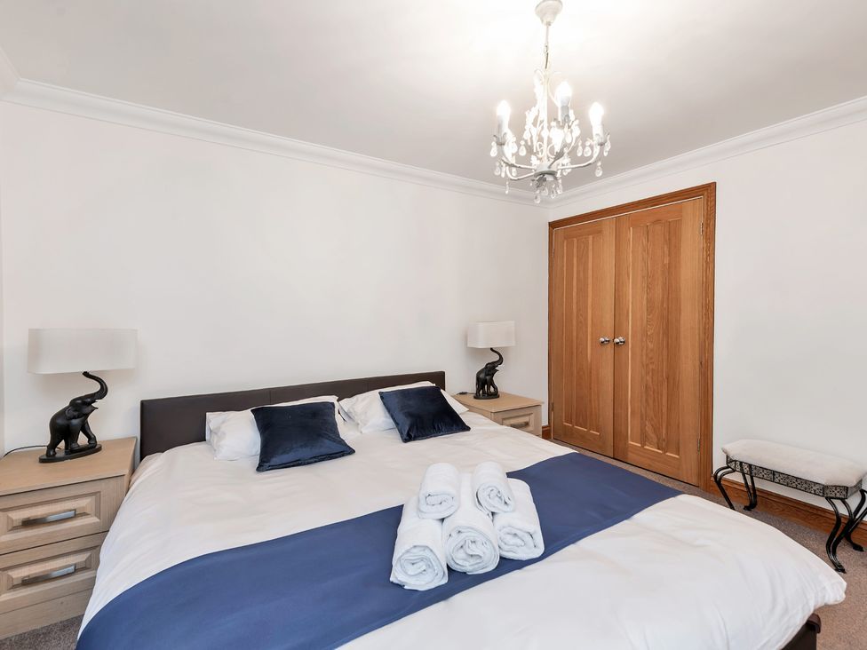 A bedroom with a bed and bedside tables at Oldfields