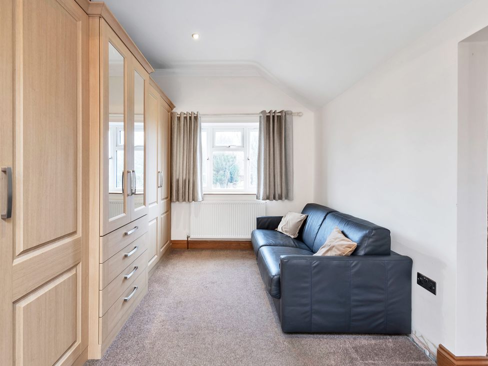 A living room with a sofa and wardrobe at Oldfields