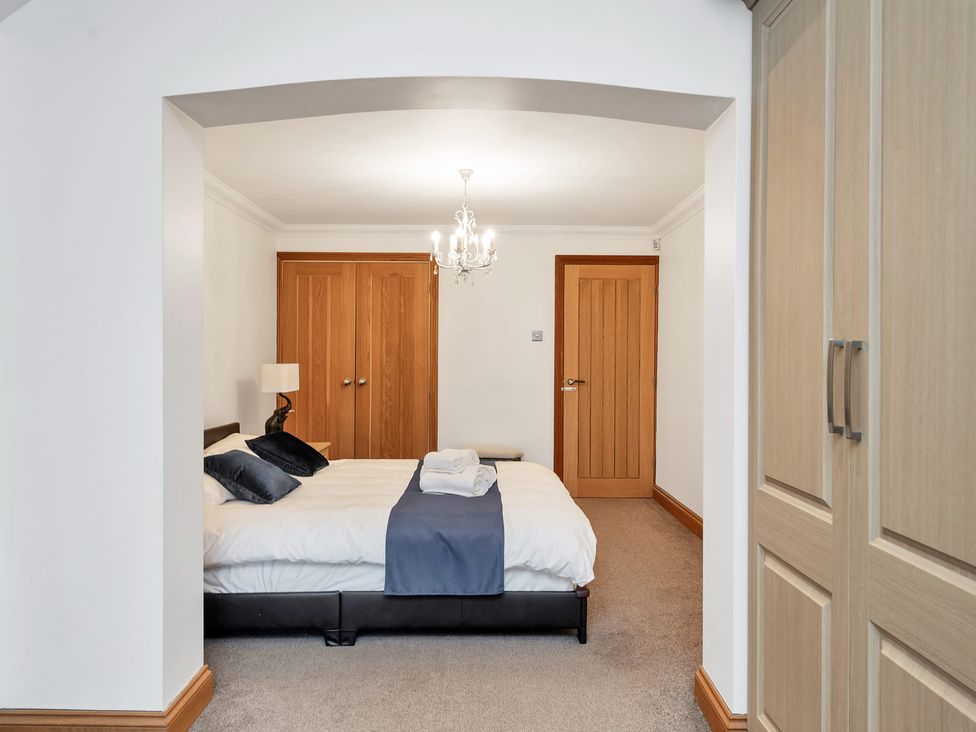 A bedroom with a bed and wardrobe at Oldfields