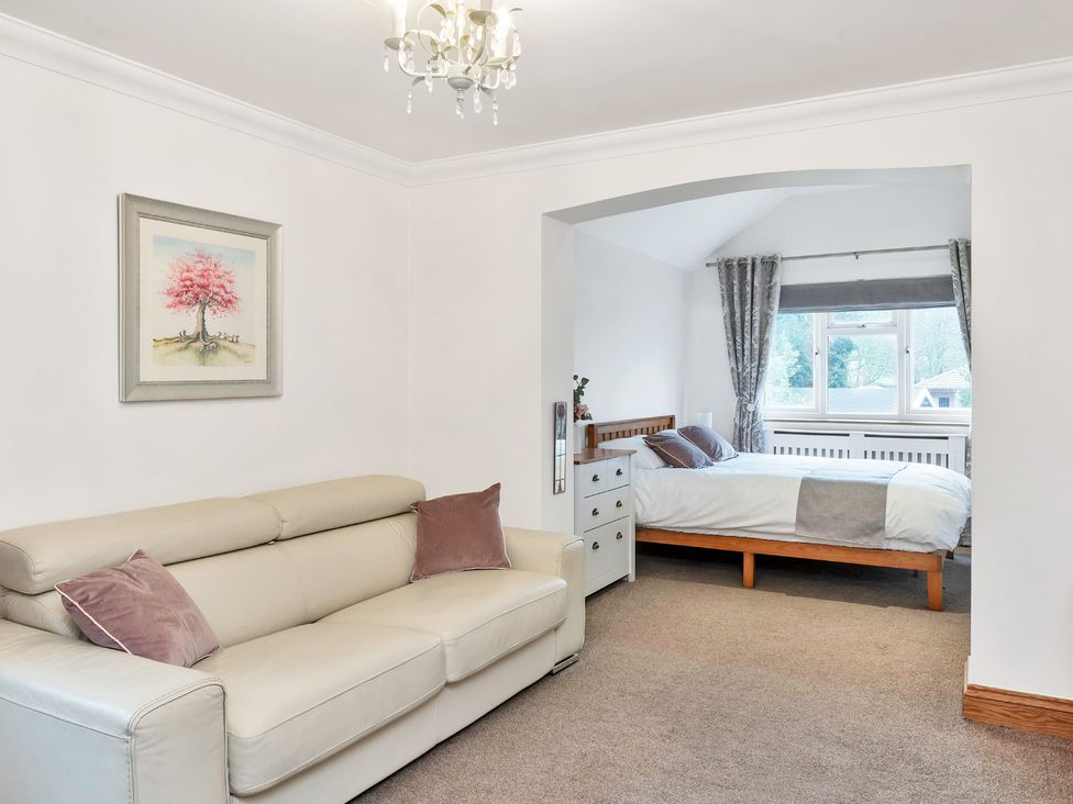 A bedroom with a bed and sofa at Oldfields