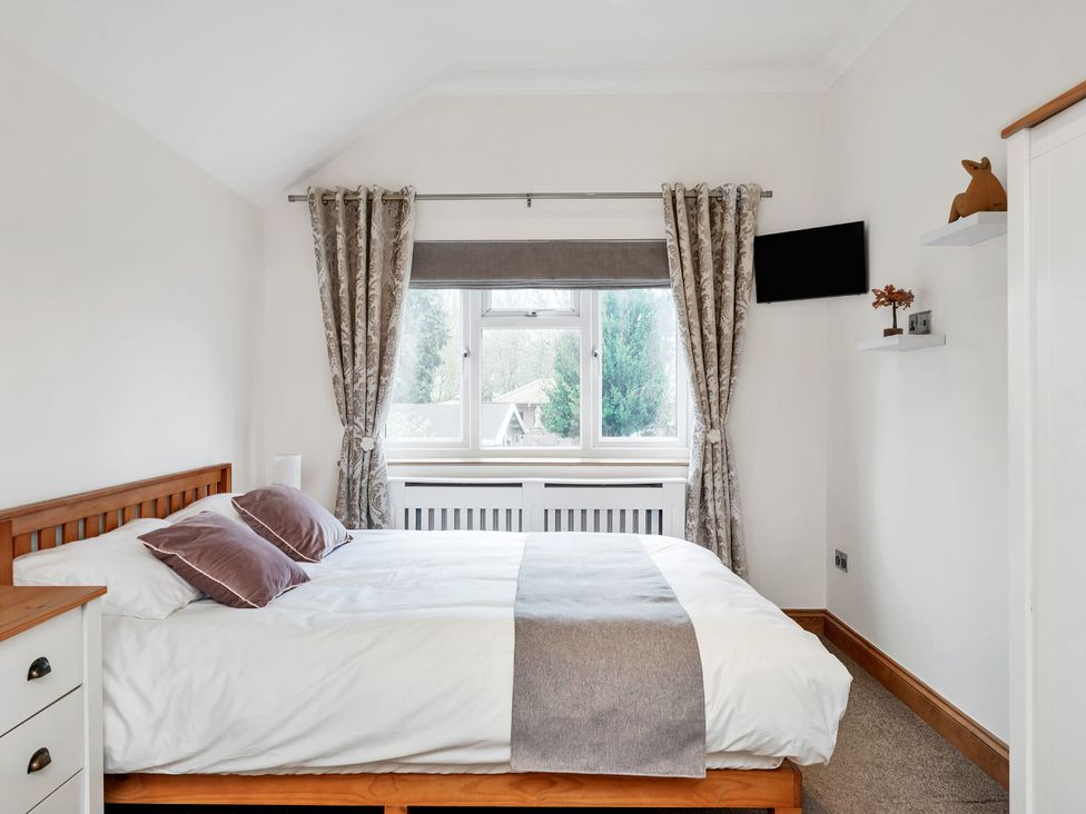A bedroom with a bed and window at Oldfields 