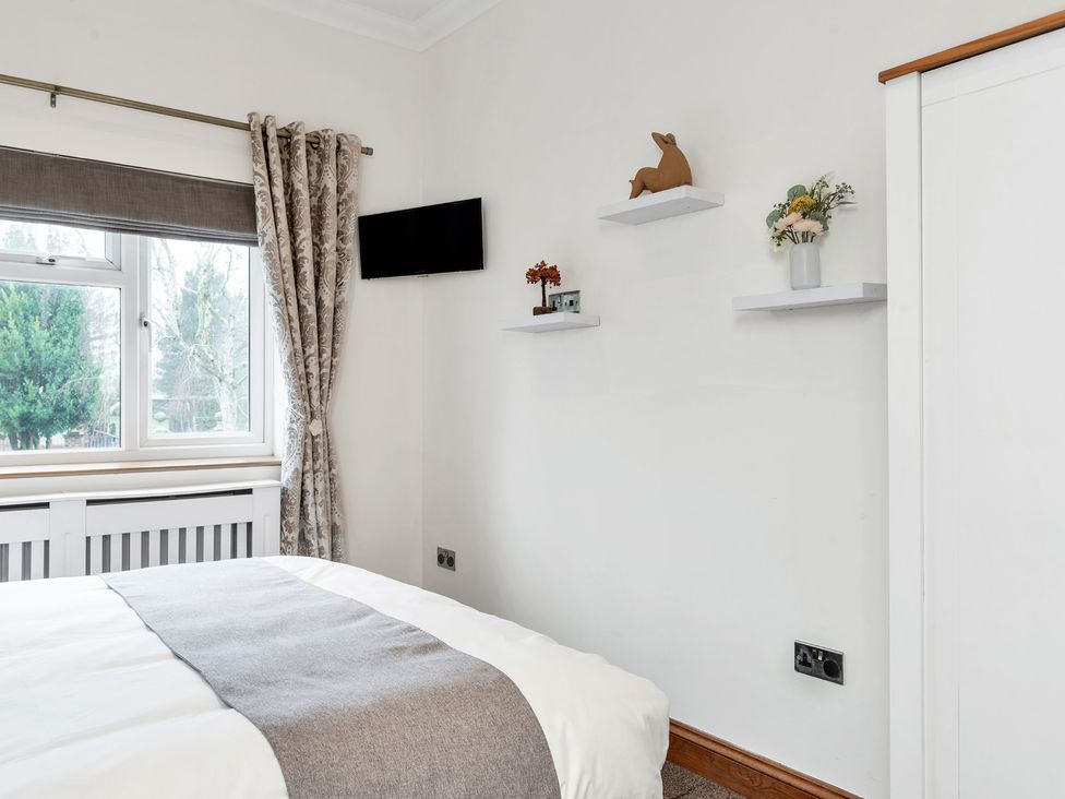 A bedroom with a bed and television at Oldfields