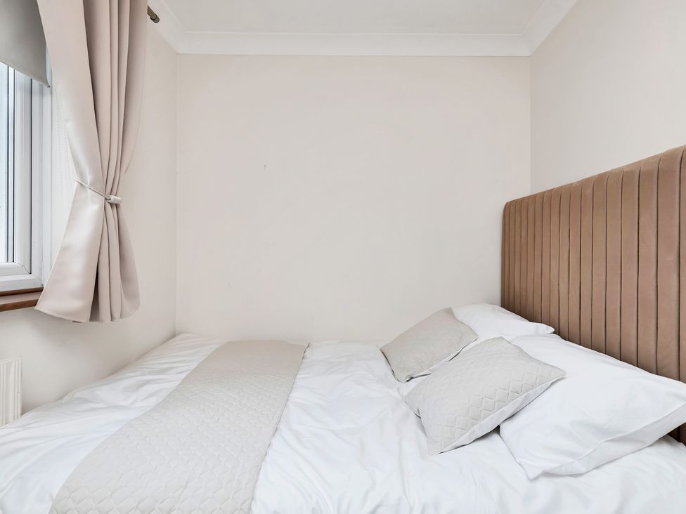 A bedroom with a bed and pillows at Oldfields