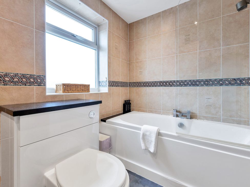 A bathroom with a bathtub and toilet at Oldfields in 