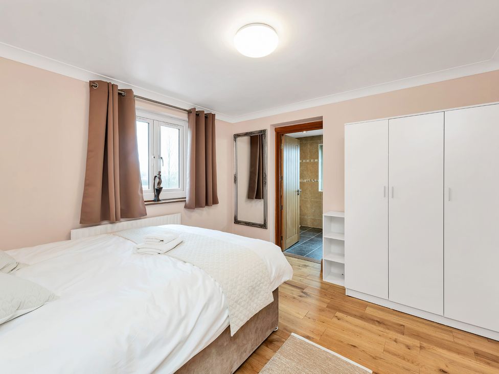 A bedroom with a bed and wardrobe at Oldfields