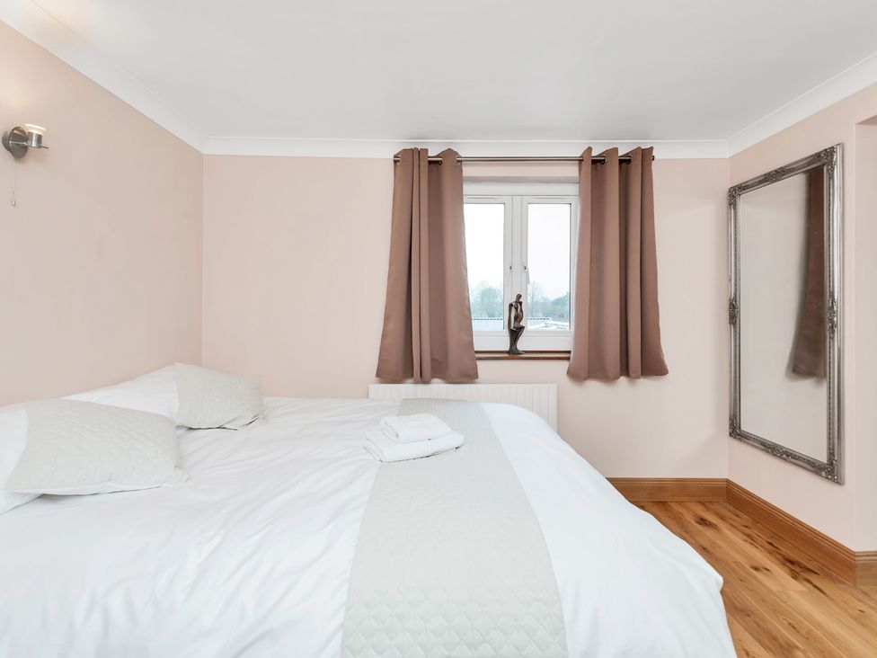 A bedroom with a bed and curtains at Oldfields