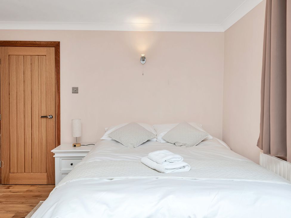 A bedroom with a bed and nightstand at Oldfields