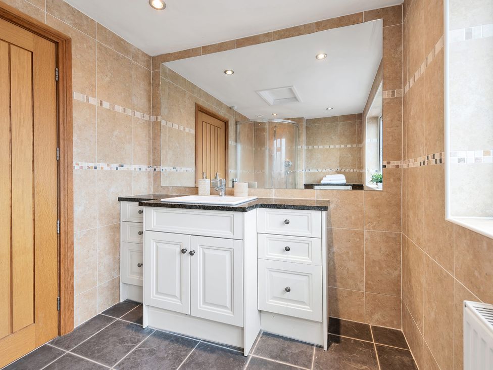 A bathroom with a sink and mirror at Oldfields