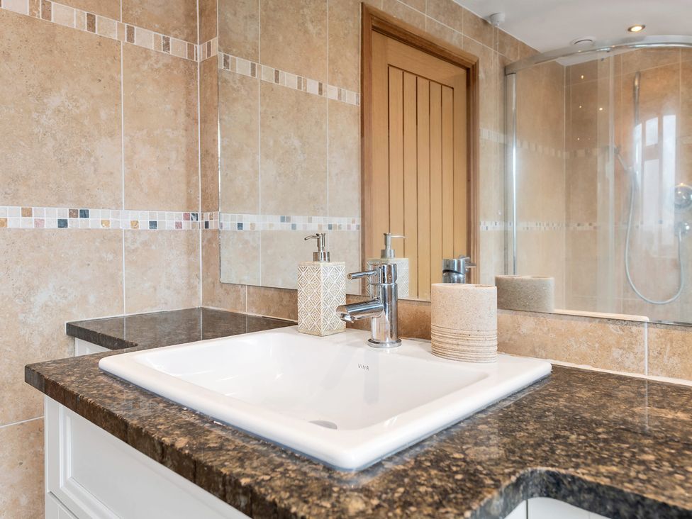 A sink with a faucet and countertop in a bathroom at Oldfields