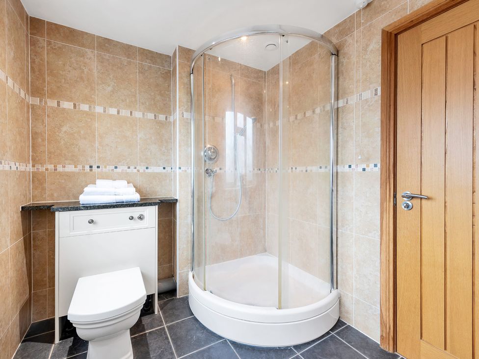 A bathroom with a shower and toilet at Oldfields