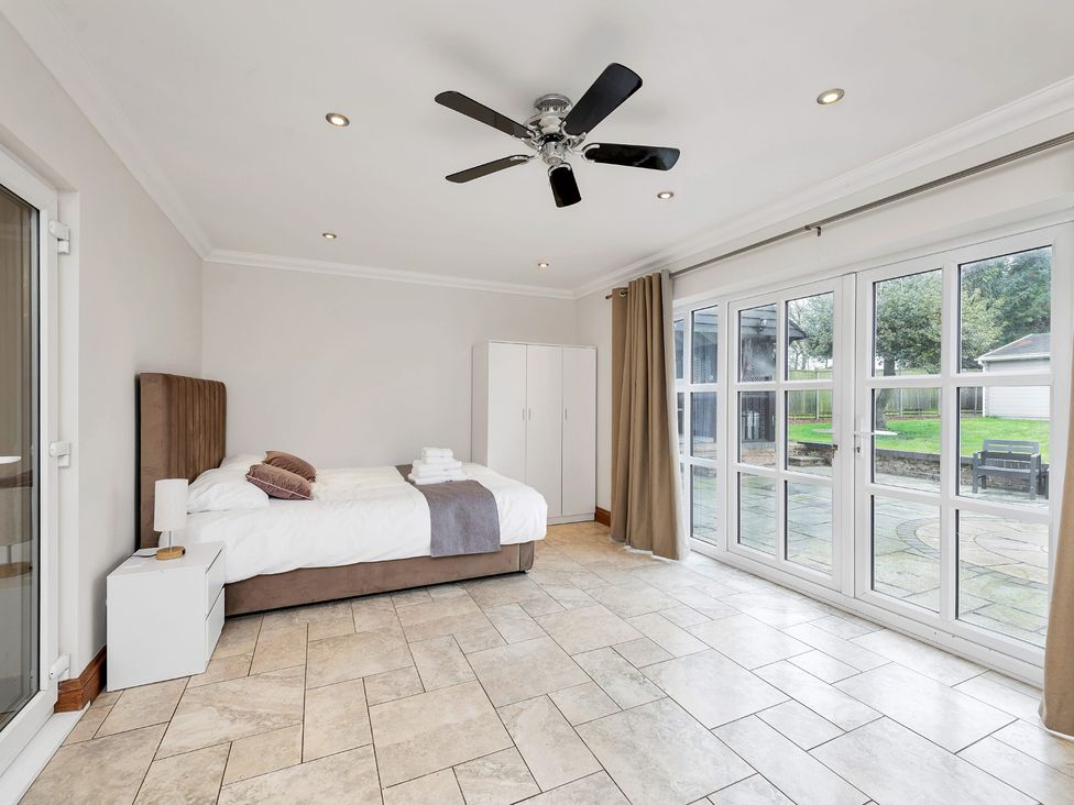 A bedroom with a bed and wardrobe at Oldfields
