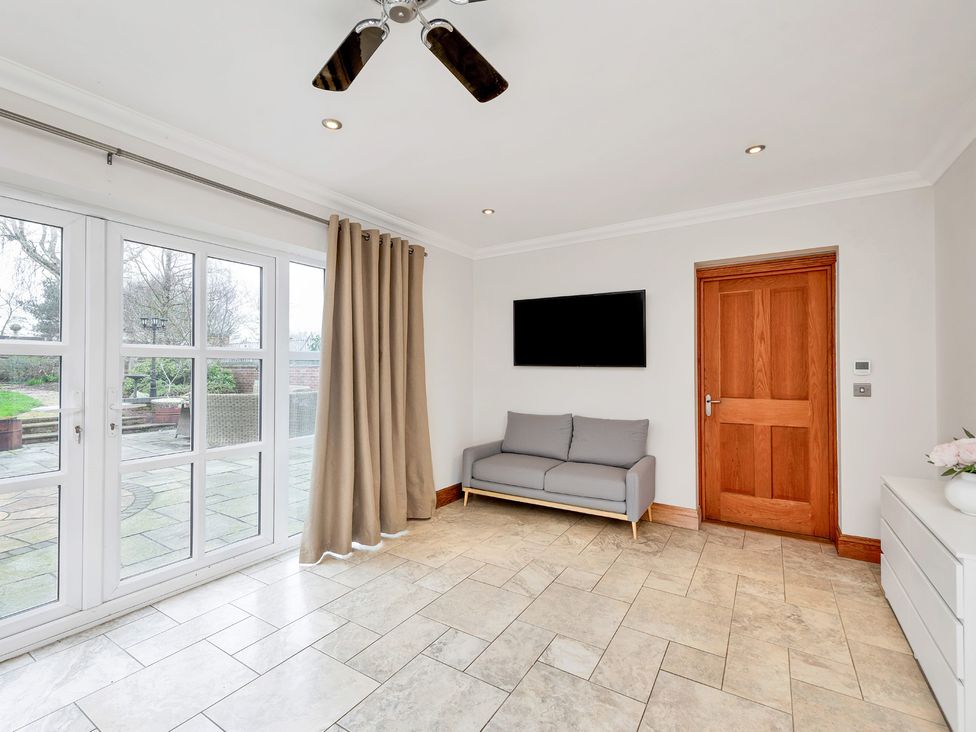 A living room with a sofa and television at Oldfields