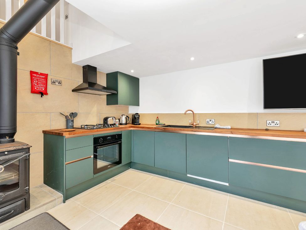 A kitchen with stove and cabinetry at Oldfields
