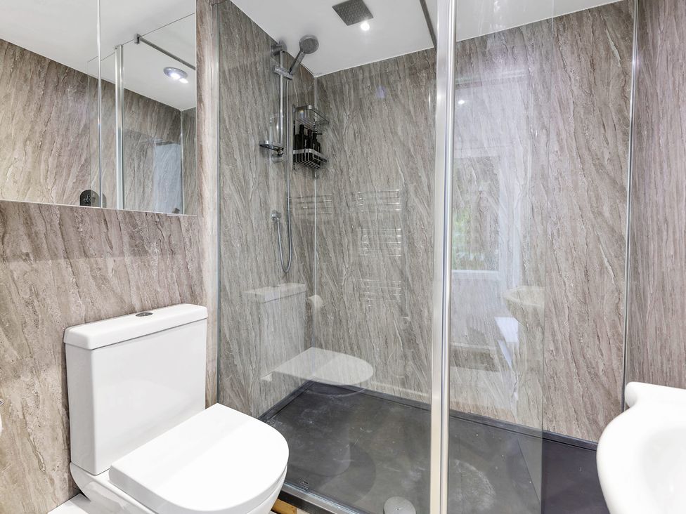 A bathroom with a shower and toilet at Oldfields