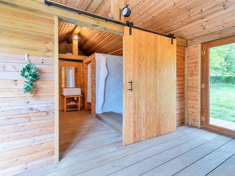 A bathroom with a wooden door and sink at Oldfields