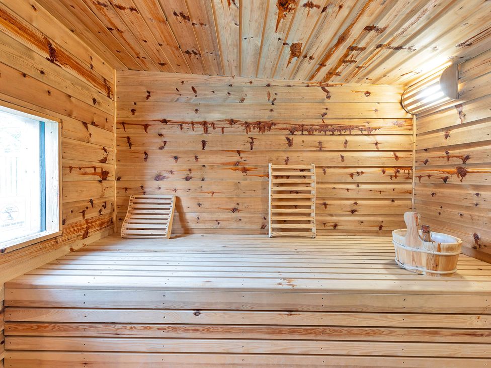 A sauna with wooden benches and a window at Oldfields