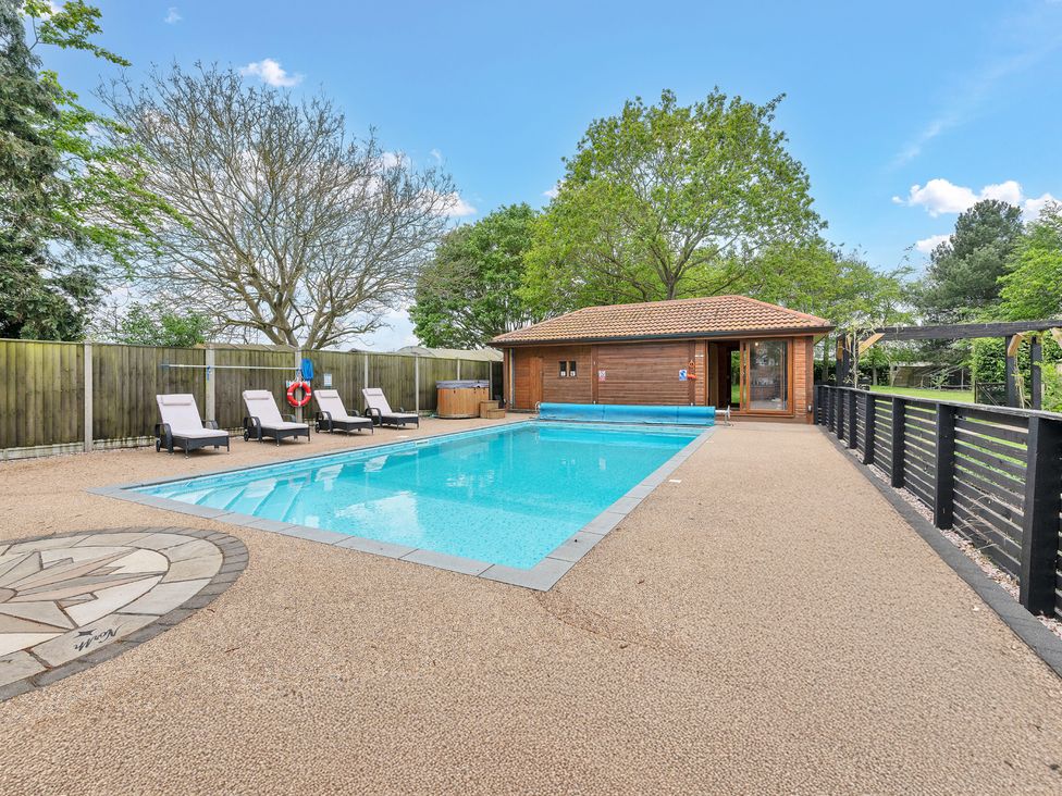 An outdoor area with a swimming pool and loungers at Oldfields