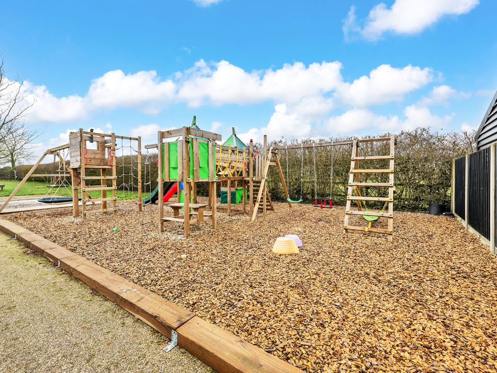 A playground with climbing frame and swings at Oldfields