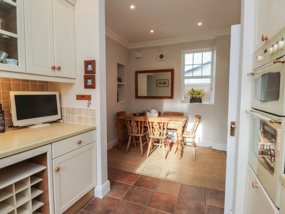 A dining room with a table and chairs at Bryniau in Pwllheli