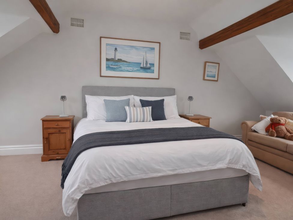 A bedroom with a bed and bedside tables at Bryniau in Morfa Nefyn