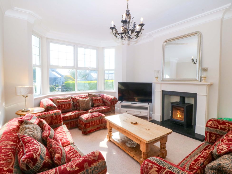 A living room with a sofa and television at Bryniau in Morfa Nefyn