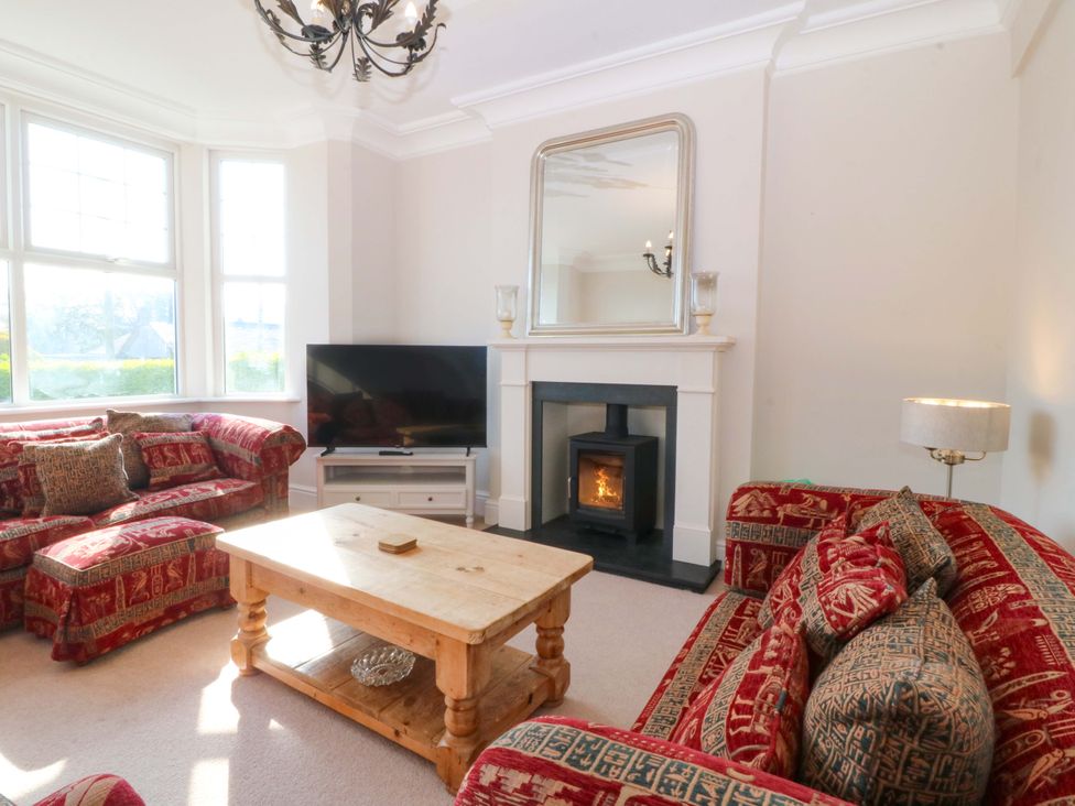A living room with a sofa and coffee table at Bryniau in Morfa Nefyn