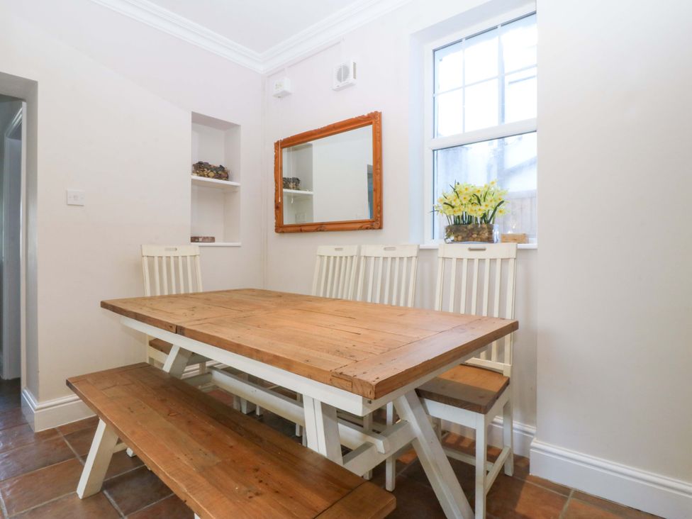 A dining room with a table and chairs at Bryniau in Morfa Nefyn