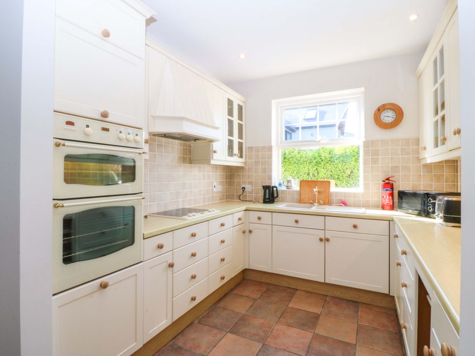 A kitchen with cabinets and appliances at Bryniau in Morfa Nefyn