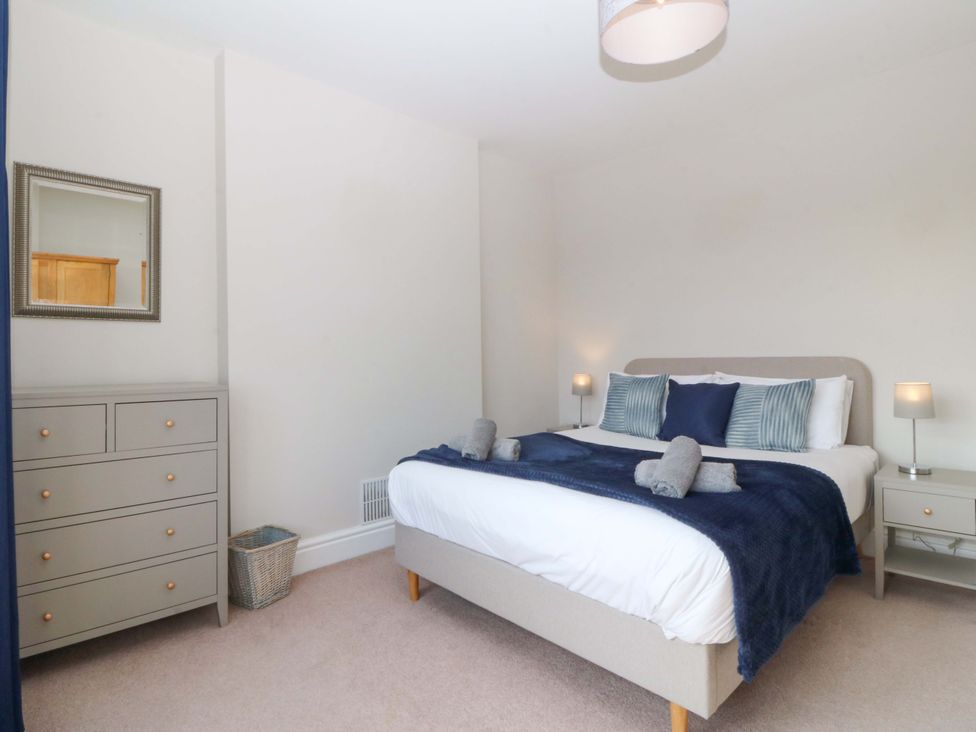 A bedroom with a bed and furniture at Bryniau in Morfa Nefyn