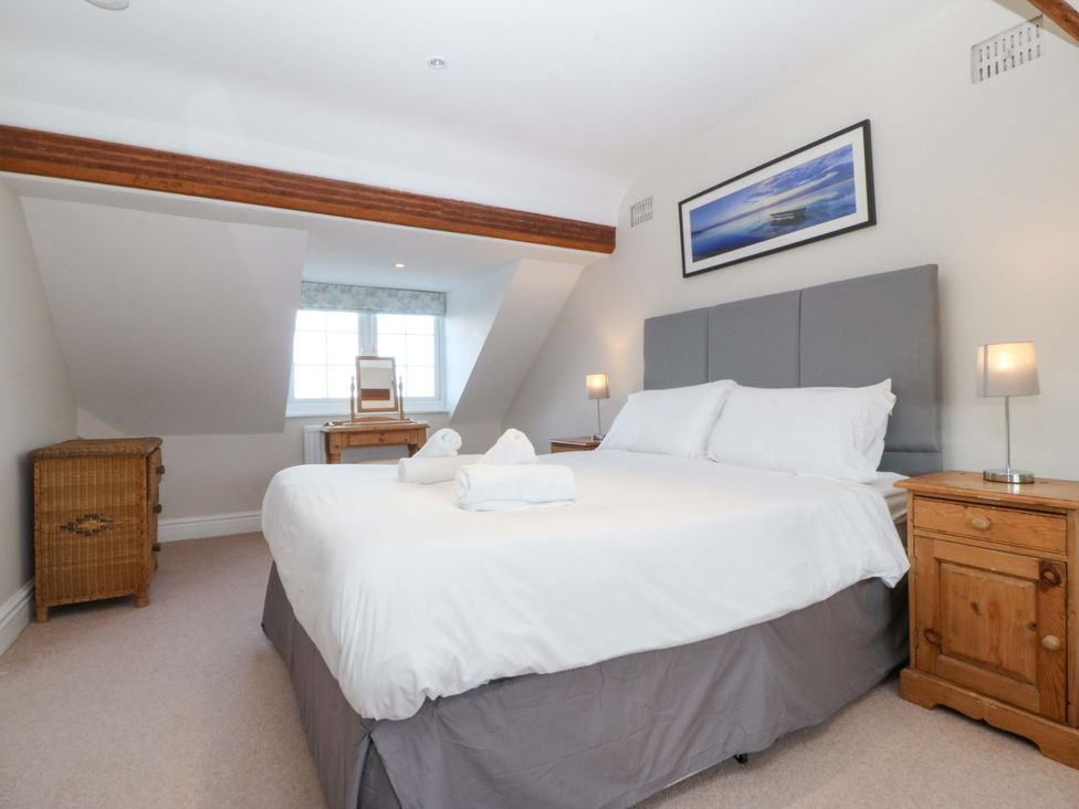 A bedroom with a bed and nightstands at Bryniau in Morfa Nefyn