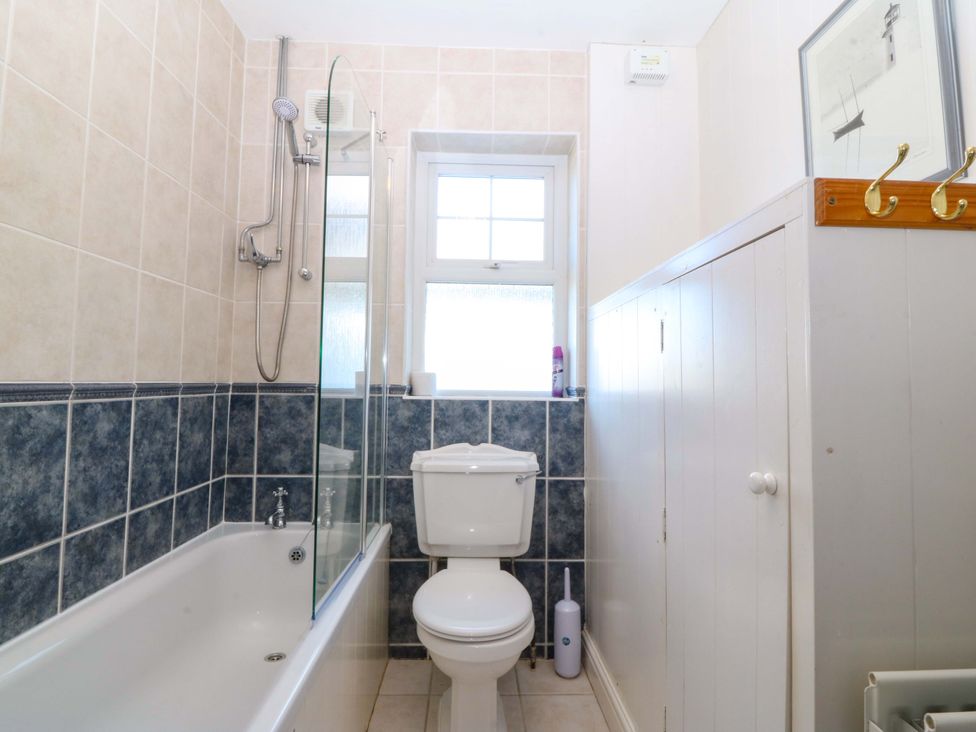 A bathroom with a bathtub, shower, and toilet at Bryniau in Morfa Nefyn