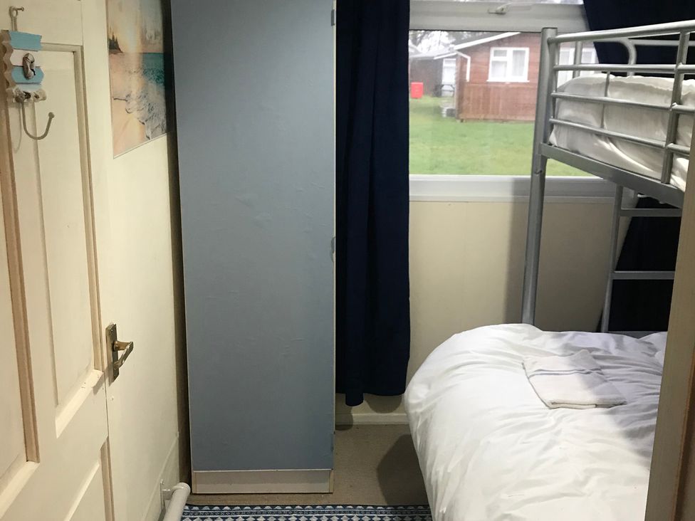 A bedroom with bunk bed and wardrobe at 187 Atlantic Bays Tregolds