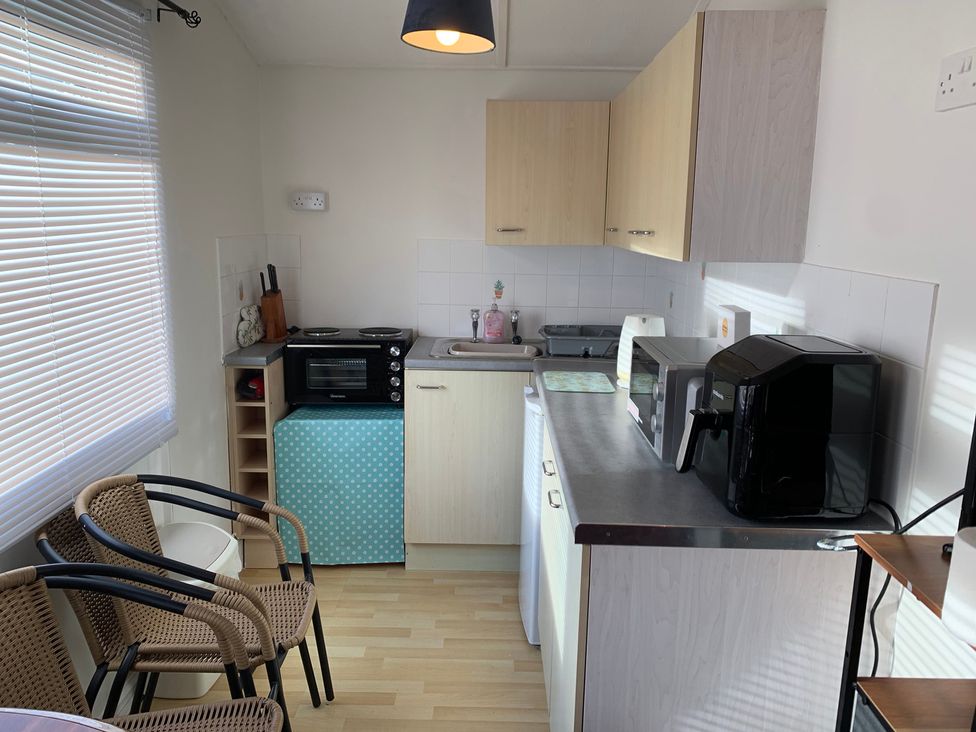 A kitchen with appliances and cabinets at 187 Atlantic Bays Tregolds