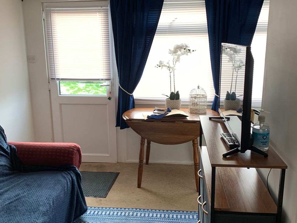 A snug with a sofa, a table, and a monitor at 187 Atlantic Bays Tregolds