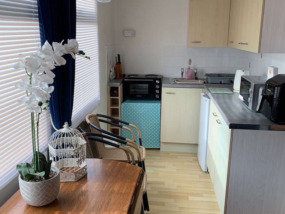 A kitchen with table and chairs at 187 Atlantic Bays in Tregolds