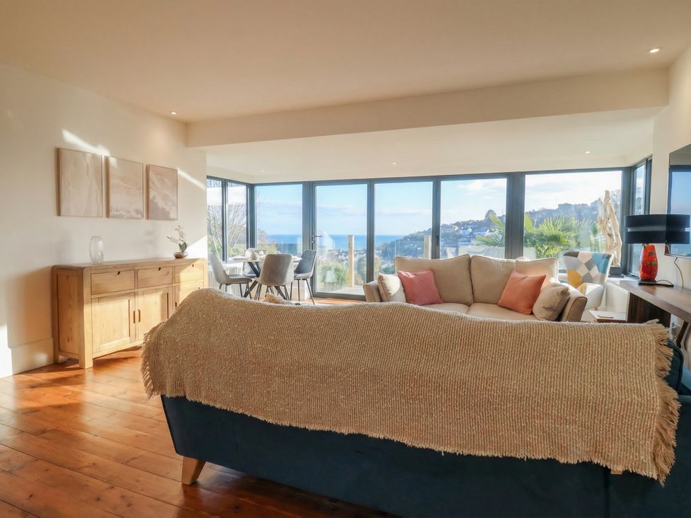 A living room with a sofa and wooden cabinet at Devona in Beer