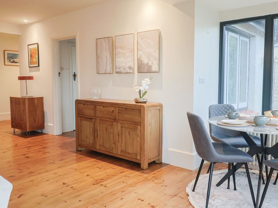 A dining room with a sideboard and a table at Devona in Beer